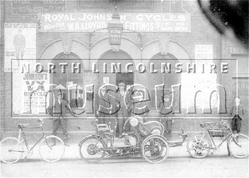 Bicycles and Motorcycles belonging to Johnson Cycles outside their Cycle and Motor Works in Home Street, Scunthorpe. 	