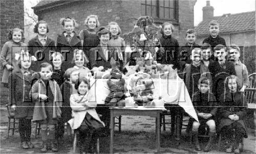 Miss Bird and pupils with toys they had made at Horkstow School, Horkstow, c.1942	