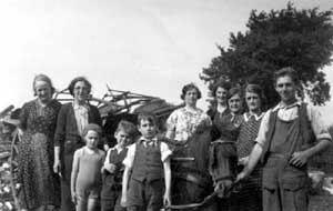 Bottesford and Yaddlethorpe Women's Institute, group surrounding scrap heaped in Yaddlethorpe High Street as part of 2nd world war effort, Yaddlethorpe 	